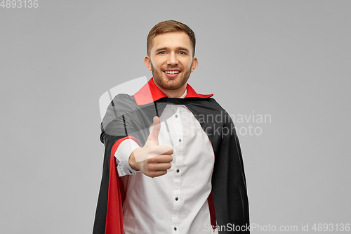 Image of happy man in costume of vampire showing thumbs up