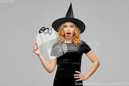 Image of woman in halloween costume of witch with accessory