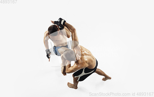 Image of Two professional MMA fighters boxing isolated on white studio background, dynamic and motion. Top view