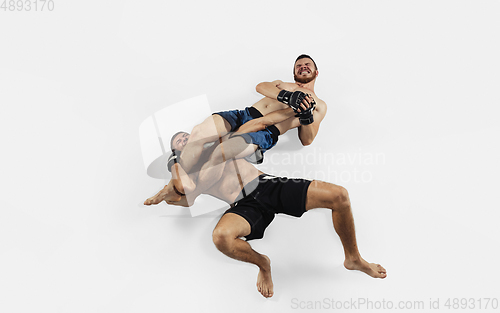 Image of Two professional MMA fighters boxing isolated on white studio background, dynamic and motion. Top view