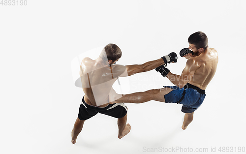 Image of Two professional MMA fighters boxing isolated on white studio background, dynamic and motion. Top view