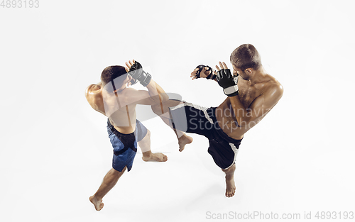 Image of Two professional MMA fighters boxing isolated on white studio background, dynamic and motion. Top view