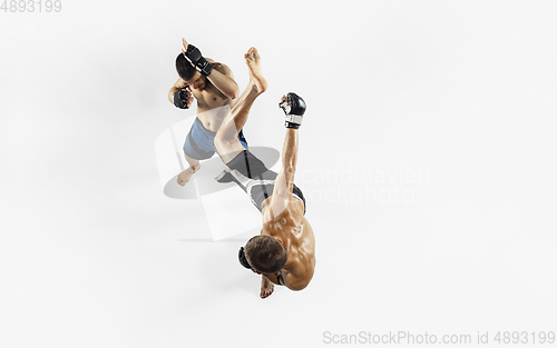 Image of Two professional MMA fighters boxing isolated on white studio background, dynamic and motion. Top view
