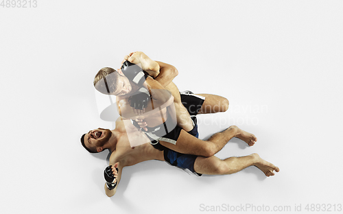 Image of Two professional MMA fighters boxing isolated on white studio background, dynamic and motion. Top view