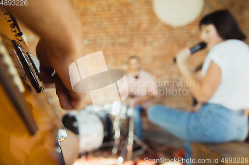 Image of Musician band jamming together in art workplace with instruments