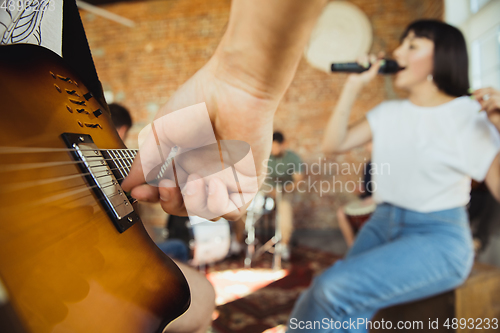 Image of Musician band jamming together in art workplace with instruments