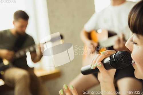 Image of Musician band jamming together in art workplace with instruments