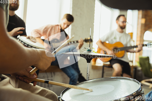 Image of Musician band jamming together in art workplace with instruments