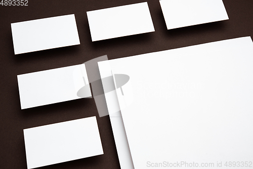 Image of Blank flyer poster isolated on brown background to replace your design