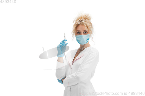 Image of Portrait of female doctor, nurse or cosmetologist in white uniform and blue gloves over white background