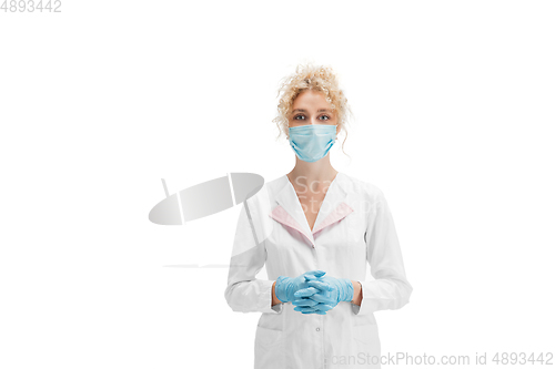 Image of Portrait of female doctor, nurse or cosmetologist in white uniform and blue gloves over white background