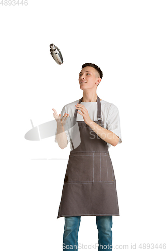 Image of Isolated portrait of a young male caucasian barista or bartender in brown apron smiling