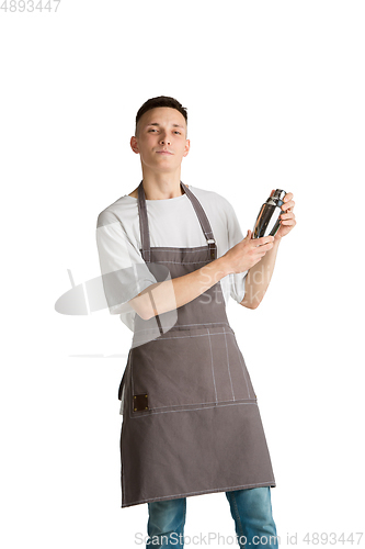 Image of Isolated portrait of a young male caucasian barista or bartender in brown apron smiling