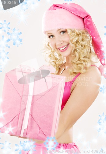 Image of cheerful santa helper girl with gift box
