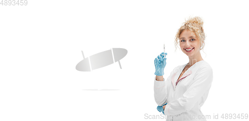 Image of Portrait of female doctor, nurse or cosmetologist in white uniform and blue gloves over white background