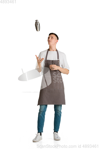 Image of Isolated portrait of a young male caucasian barista or bartender in brown apron smiling