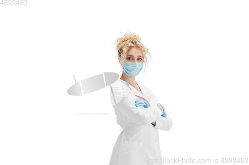 Image of Portrait of female doctor, nurse or cosmetologist in white uniform and blue gloves over white background