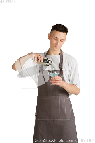 Image of Isolated portrait of a young male caucasian barista or bartender in brown apron smiling