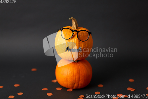 Image of halloween pumpkins with glasses and bat