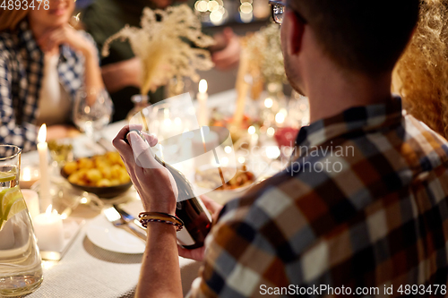 Image of happy friends with red wine at christmas party