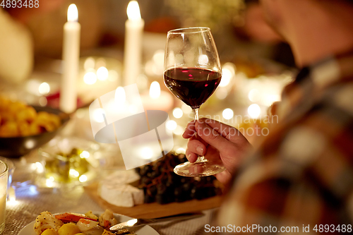 Image of friends drinking red wine at christmas party