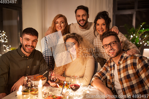Image of friends taking selfie at christmas dinner party