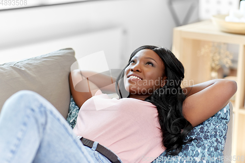 Image of happy african american young woman at home