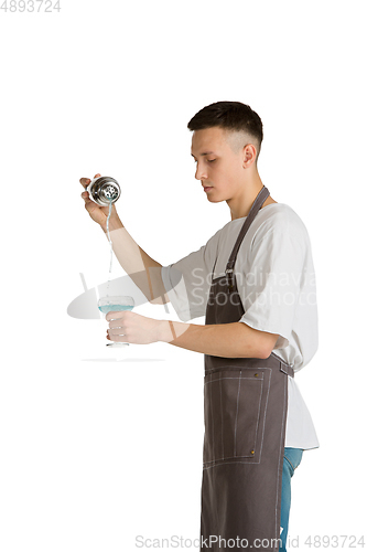 Image of Isolated portrait of a young male caucasian barista or bartender in brown apron smiling