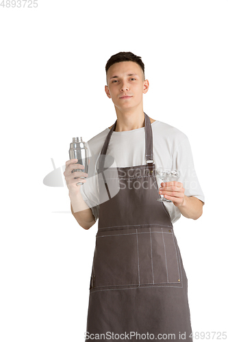 Image of Isolated portrait of a young male caucasian barista or bartender in brown apron smiling