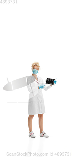 Image of Portrait of female doctor, nurse or cosmetologist in white uniform and blue gloves over white background