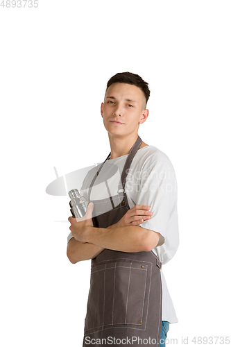 Image of Isolated portrait of a young male caucasian barista or bartender in brown apron smiling