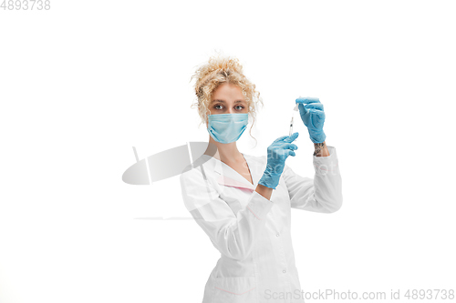 Image of Portrait of female doctor, nurse or cosmetologist in white uniform and blue gloves over white background