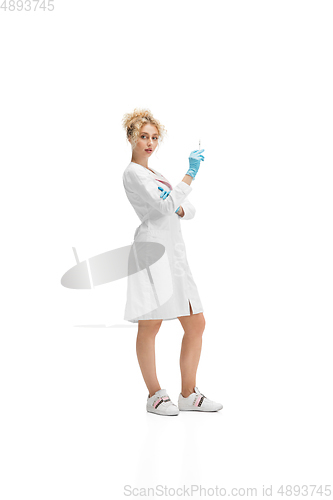 Image of Portrait of female doctor, nurse or cosmetologist in white uniform and blue gloves over white background