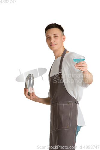 Image of Isolated portrait of a young male caucasian barista or bartender in brown apron smiling