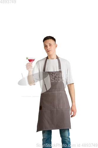 Image of Isolated portrait of a young male caucasian barista or bartender in brown apron smiling