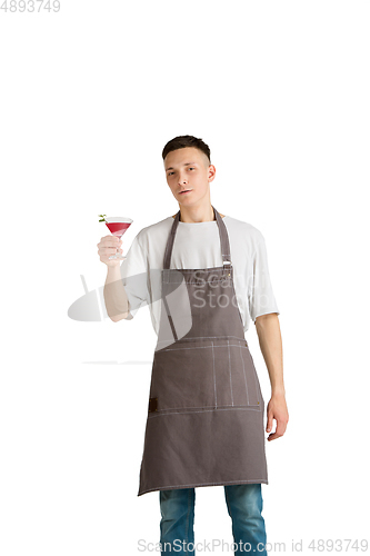 Image of Isolated portrait of a young male caucasian barista or bartender in brown apron smiling