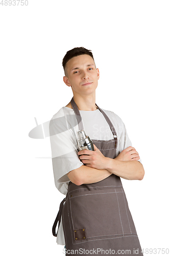 Image of Isolated portrait of a young male caucasian barista or bartender in brown apron smiling