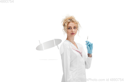 Image of Portrait of female doctor, nurse or cosmetologist in white uniform and blue gloves over white background