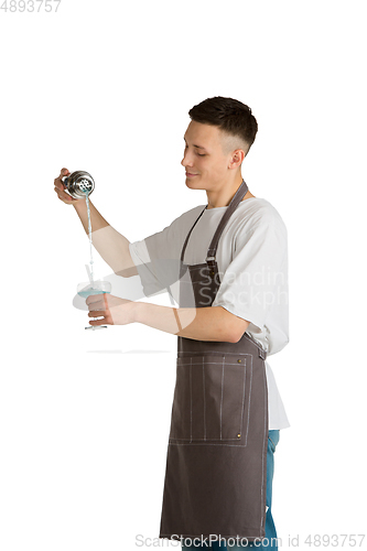 Image of Isolated portrait of a young male caucasian barista or bartender in brown apron smiling