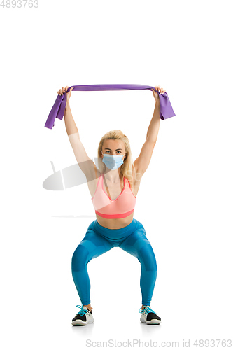 Image of Beautiful female fitness coach practicing isolated on white studio background