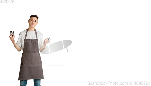 Image of Isolated portrait of a young male caucasian barista or bartender in brown apron smiling