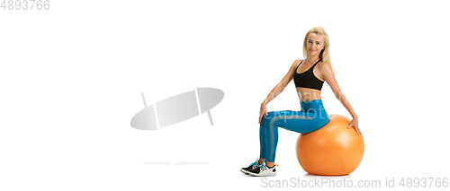 Image of Beautiful female fitness coach practicing isolated on white studio background