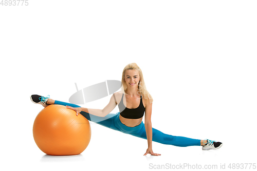 Image of Beautiful female fitness coach practicing isolated on white studio background