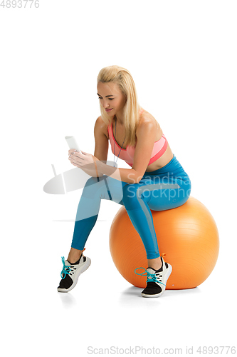 Image of Beautiful female fitness coach practicing isolated on white studio background