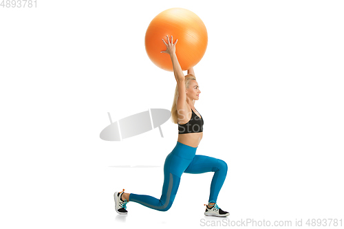 Image of Beautiful female fitness coach practicing isolated on white studio background