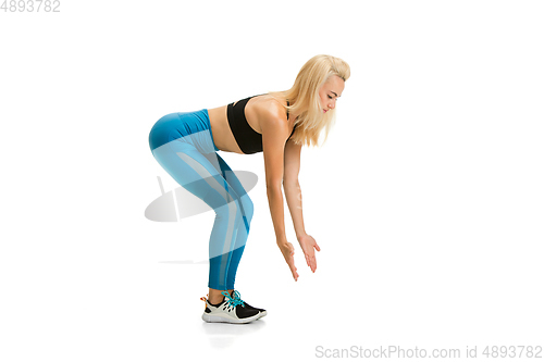 Image of Beautiful female fitness coach practicing isolated on white studio background