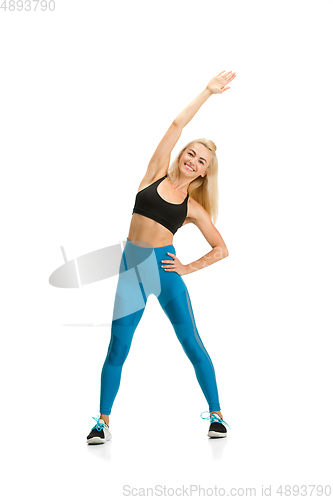 Image of Beautiful female fitness coach practicing isolated on white studio background