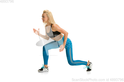 Image of Beautiful female fitness coach practicing isolated on white studio background