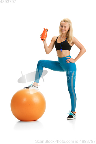 Image of Beautiful female fitness coach practicing isolated on white studio background