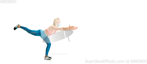 Image of Beautiful female fitness coach practicing isolated on white studio background